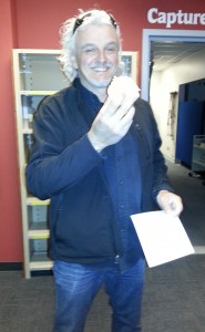 A smiling CMG member takes a break with his orange.